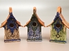 three birdhouses in different colors